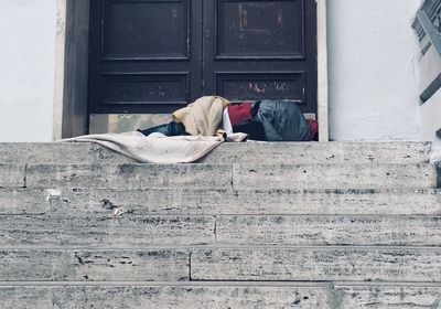 Man sleeping in front of building