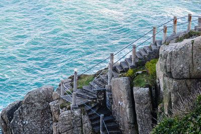 High angle view of rocks by sea