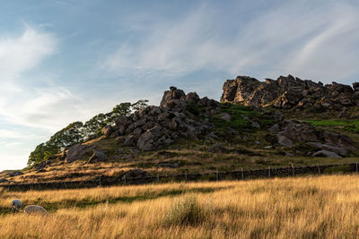 Rock formations on landscape against sky