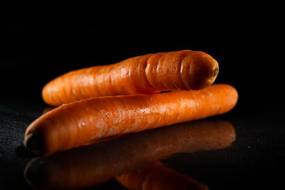 Close-up of pumpkin on table against black background