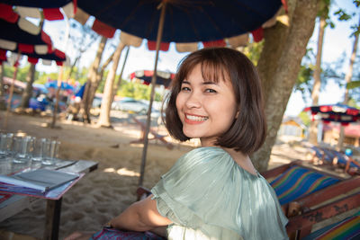 Portrait of smiling woman sitting outdoors