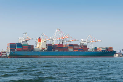 Commercial dock by sea against sky