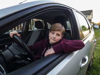 Portrait of man sitting in car