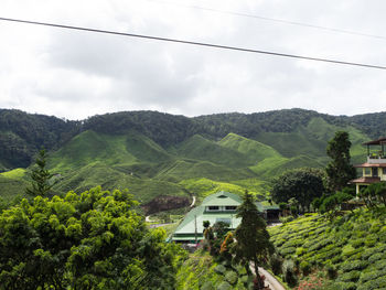 Scenic view of trees and mountains against sky