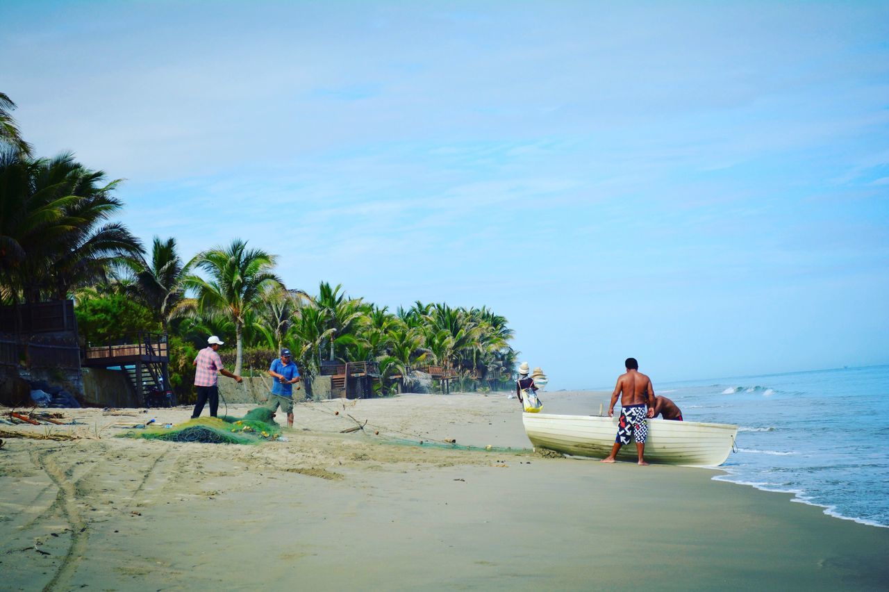 beach, leisure activity, men, lifestyles, sand, sea, transportation, person, water, shore, togetherness, mode of transport, full length, sky, vacations, tree, rear view, bicycle