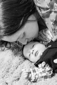 Mother and son lying on bed