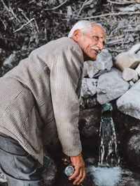 Full length portrait of man standing in water