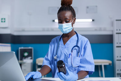 Nurse holding medicine in clinic