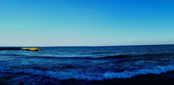 Scenic view of calm sea against blue sky