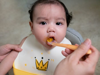 Close-up portrait of cute boy eating food