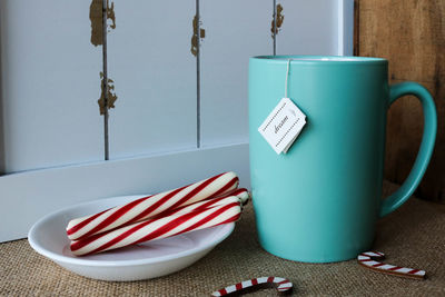 Close-up of drink with candy canes on table