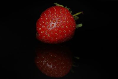 Close-up of wet apple against black background