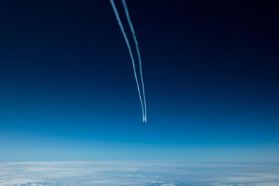 Low angle view of sky with contrail 