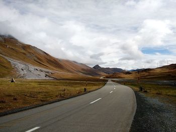 Empty road with mountains in background