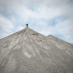 Low angle view of tower on mountain against sky