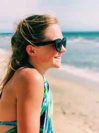 Close-up of young woman standing on beach