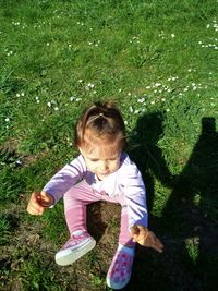 High angle view of girl on grassy field