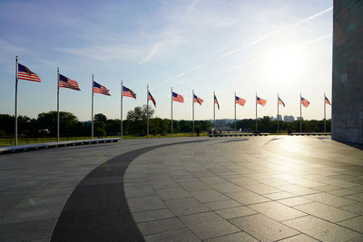 Alignment of american flags in the wind at washington monument during summer sunset 