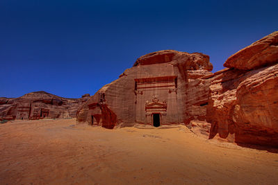 Rock formations in desert against clear blue sky