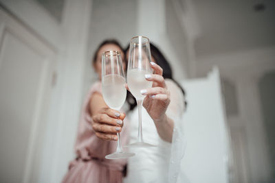 Midsection of person holding glass