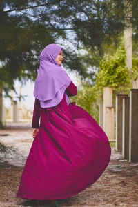 Rear view of woman in traditional clothing standing on ground