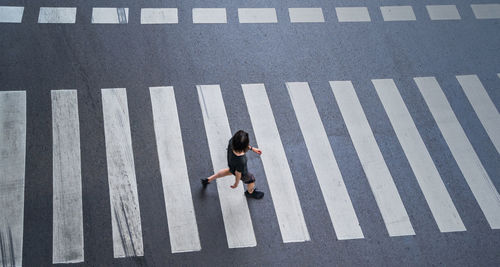 High angle view of man walking on road