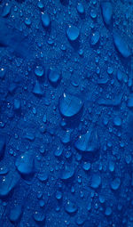 Full frame shot of raindrops on blue water