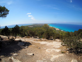 View of calm beach against blue sky