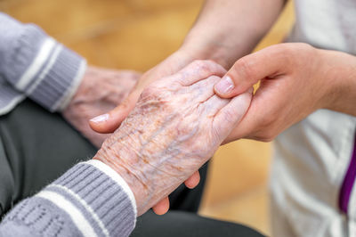 Midsection of couple holding hands