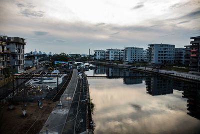 High angle view of bridge over river amidst buildings in city