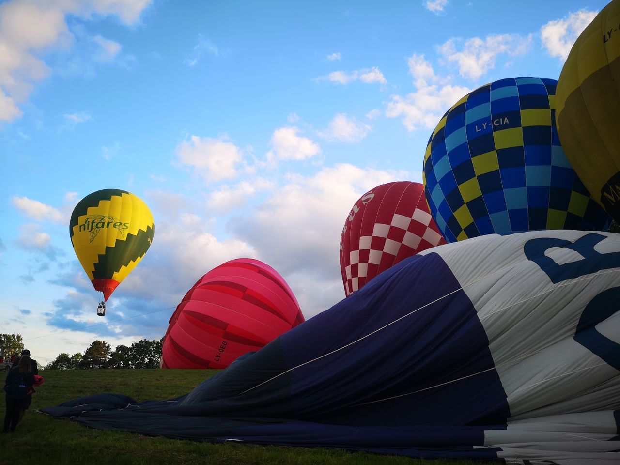 LOW ANGLE VIEW OF HOT AIR BALLOONS AGAINST BLUE SKY