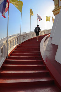 Rear view of people walking on staircase