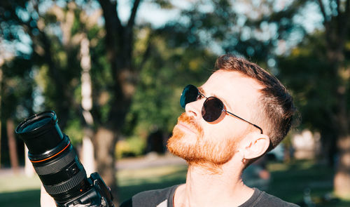 Close-up portrait of young man wearing sunglasses