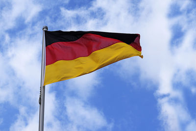 Low angle view of belgian flag against sky