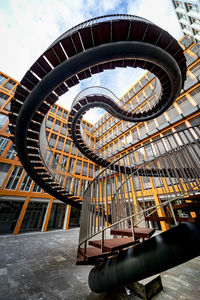 Low angle view of ferris wheel against building