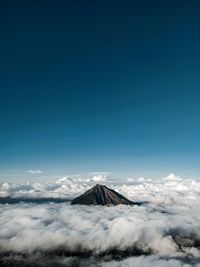 Scenic view of snowcapped mountains against blue sky