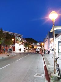 Illuminated city street at night