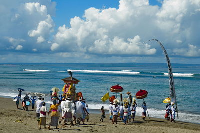 People on beach against sky