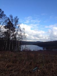 Scenic view of lake against cloudy sky