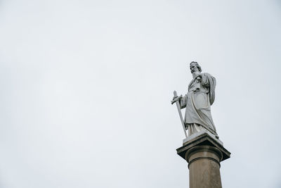 Low angle view of statue against sky