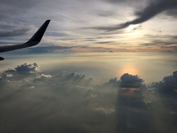 Airplane flying over cloudscape against the sky