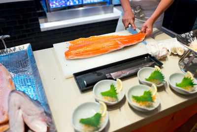 Midsection of man preparing food