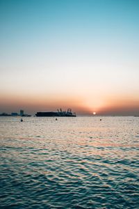 Scenic view of sea against clear sky during sunset