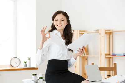 Portrait of smiling young woman at office
