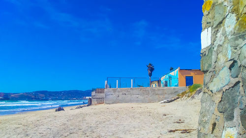 Scenic view of beach against blue sky