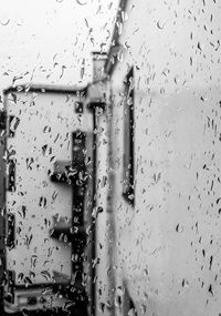 Full frame shot of wet glass window during rainy season