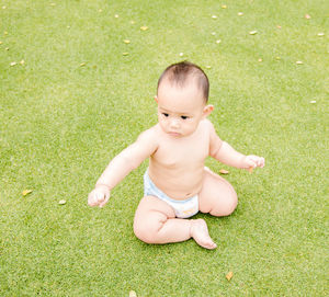 Full length of cute baby girl playing on field at public park