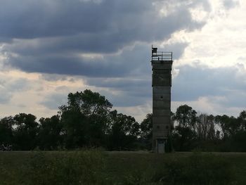 Built structure on field against sky