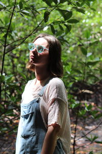 Young woman looking at camera in forest