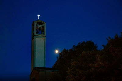 Low angle view of illuminated tower against sky at night